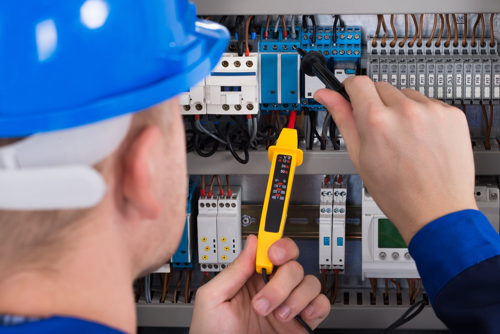 Male Electrician Checking Fusebox